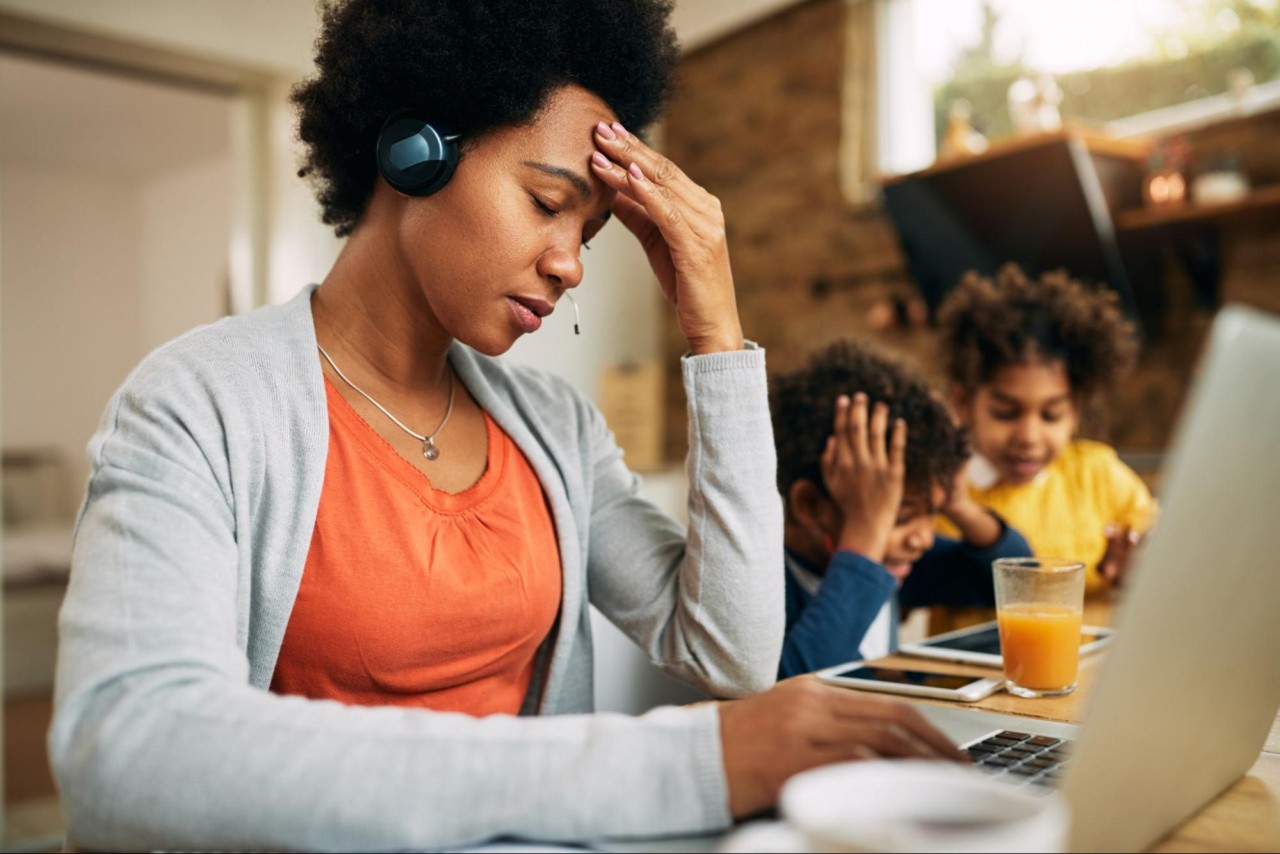 Parents under pressure - Parent showing signs of stress while trying to work 